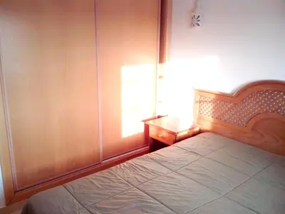 a bedroom with a bed and a wooden wall at Charming Apartment in Albufeira with Shared Pool in Albufeira