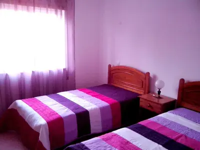 a bedroom with two beds and a window at Charming Apartment in Albufeira with Shared Pool in Albufeira