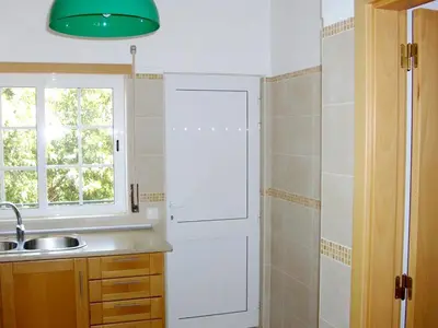 a kitchen with a sink and a window at Charming Apartment in Albufeira with Shared Pool in Albufeira