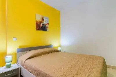 a bedroom with a bed and a yellow wall at ★Traditional House★Heart of Oldtown★ Amazing views in Albufeira