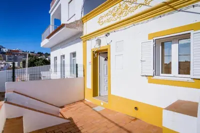 a white and yellow house with a balcony at ★Traditional House★Heart of Oldtown★ Amazing views in Albufeira