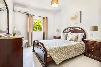 a bedroom with a bed and a dresser and a window at Villa Chiquito Albufeira - Private Pool&Parking - BBQ&AC&WI-FI in Albufeira
