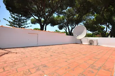 a swimming pool with chairs in a yard at Delightful single-storey villa, private pool, free air conditioning and wifi in Vilamoura
