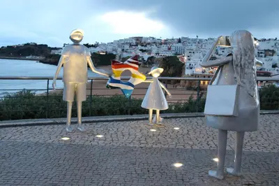 three statues of a woman and a girl looking at a city at Pine Tree Seaside Apartments 500m to Beach in Albufeira