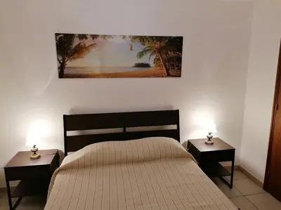 a bedroom with a bed and two nightstands with lamps at Oceana in Faro