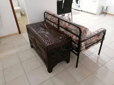 a brown bench sitting on a tiled floor at Oceana in Faro