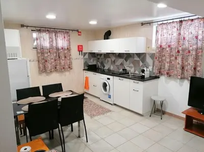 a kitchen with a table and chairs and a microwave at Oceana in Faro
