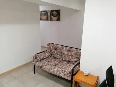 a couch in a room with a picture on the wall at Oceana in Faro