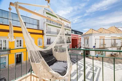 a hammock on the balcony of a building at Downtown Lux Apartment in Faro