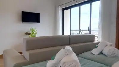 a living room with a couch with towels on it at Sea View5 in Albufeira