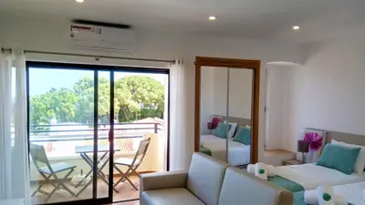 a living room with a couch and a room with a balcony at Sea View5 in Albufeira