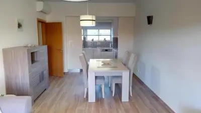 a white dining room table and chairs in a room at Albufeira Premium Apartment in Albufeira