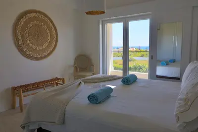 a bedroom with a large bed with blue pillows on it at Villa Bellevue in Albufeira