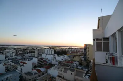 a view of a city at sunset from a building at Wonderful view in the city center in Faro