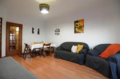 a living room with a couch and a table at Wonderful view in the city center in Faro