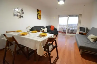 a living room with a table and a couch at Wonderful view in the city center in Faro