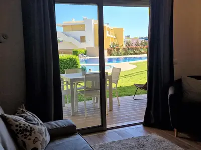 a sliding glass door leading to a patio with a table at Albufeira Prime Apartment in Albufeira