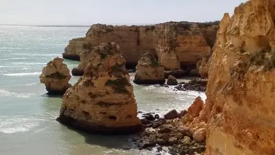 a group of large rocks in the ocean at Albufeira Prime Apartment in Albufeira
