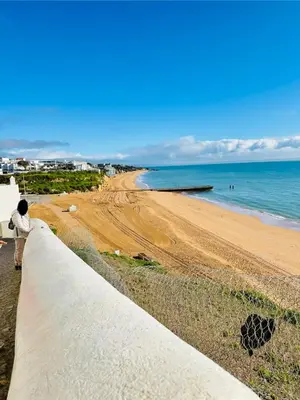 a person standing on a wall looking at the beach at Apartment Old Town Telheiros in Albufeira