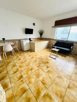 a living room with a couch and a table at Apartment Old Town Telheiros in Albufeira
