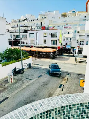 a car parked in a parking lot in front of buildings at Apartment Old Town Ferreira de Castro in Albufeira