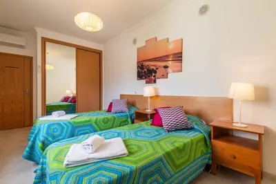 a hotel room with two beds with towels on them at Bosque São José by Algarneto in Albufeira