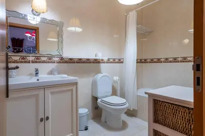 a bathroom with a toilet and a sink and a mirror at Bosque São José by Algarneto in Albufeira