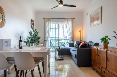 a living room with a couch and a table at Bosque São José by Algarneto in Albufeira