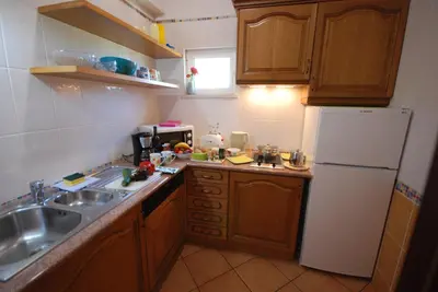 a small kitchen with a sink and a refrigerator at VILLA EBER - independent 1 & 2 bedroom apartments, pool, air con, fast Wi-Fi, near old town of Albufeira and beaches in Albufeira