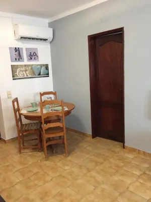 a dining room with a table and chairs and a door at Apartment Sea View 20m to beach - TOP Quarteira ALGARVE in Quarteira