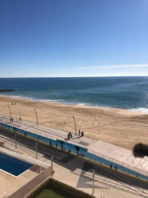 a view of a beach and the ocean from a building at Apartment Sea View 20m to beach - TOP Quarteira ALGARVE in Quarteira