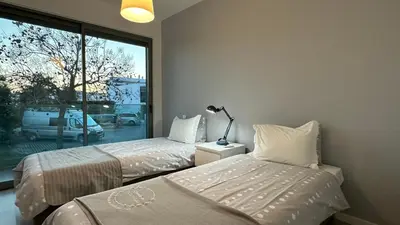 two beds in a room with a window at Albuhera - Private Pool - 8 Pax - Albufeira in Albufeira