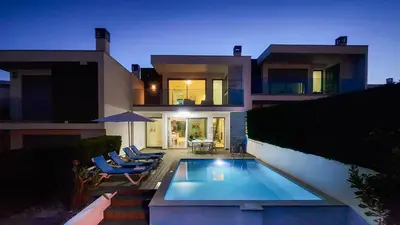 a house with a swimming pool and some chairs at Albuhera - Private Pool - 8 Pax - Albufeira in Albufeira