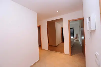 an empty room with a mirror and a hallway at Quarteira Beach in Quarteira