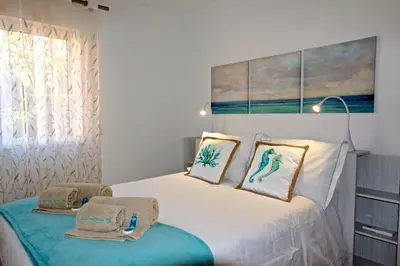 a bedroom with a bed with two towels on it at Marina Plaza 162 - Clever Details in Vilamoura