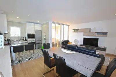 a kitchen and living room with a table and chairs at Marina Plaza 162 - Clever Details in Vilamoura