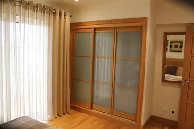 a room with a glass cabinet and a window at Luxury 3 Bedroom Apartment on Gated Complex in Quarteira