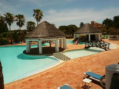 a swimming pool with a gazebo and a resort at Luxury 2 Bedroom Apartment with Private Garden in Almancil