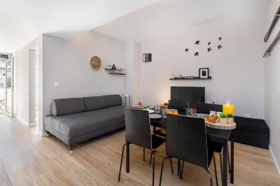 a living room with a table and a couch at Cool Grey Albufeira in Albufeira