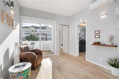 a living room with a couch and a table at Natural Grey Albufeira in Albufeira