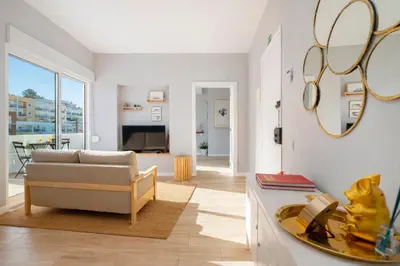 a living room with a couch and a table at Natural Grey Albufeira in Albufeira
