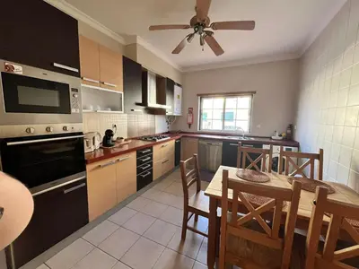 a kitchen with a table and a dining room at Rockfield 4 in Albufeira