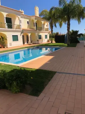 a villa with a swimming pool in front of a house at Rockfield 4 in Albufeira