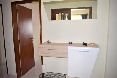 a bathroom with a sink and a mirror at Quarteira Comfortable Apartment in Quarteira