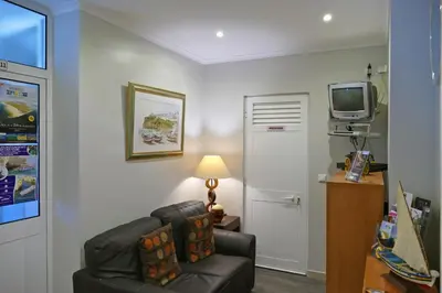 a living room with a couch and a tv at Guest House Sao Filipe in Faro