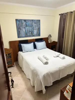 a bedroom with a bed with two towels on it at Casa #SerJo in São Brás de Alportel
