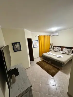 a living room with a bed and a couch at Casa #SerJo in São Brás de Alportel