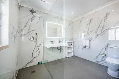 a bathroom with a shower and a toilet and a sink at Villa Marquesa in Guia