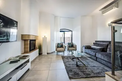 a living room with a couch and a fireplace at Villa Marquesa in Guia
