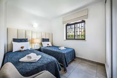 a bedroom with two beds and a window at Villa Marquesa in Guia
